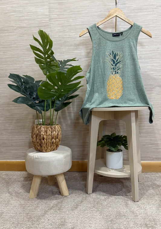 Green tank top with a pineapple design on a white background