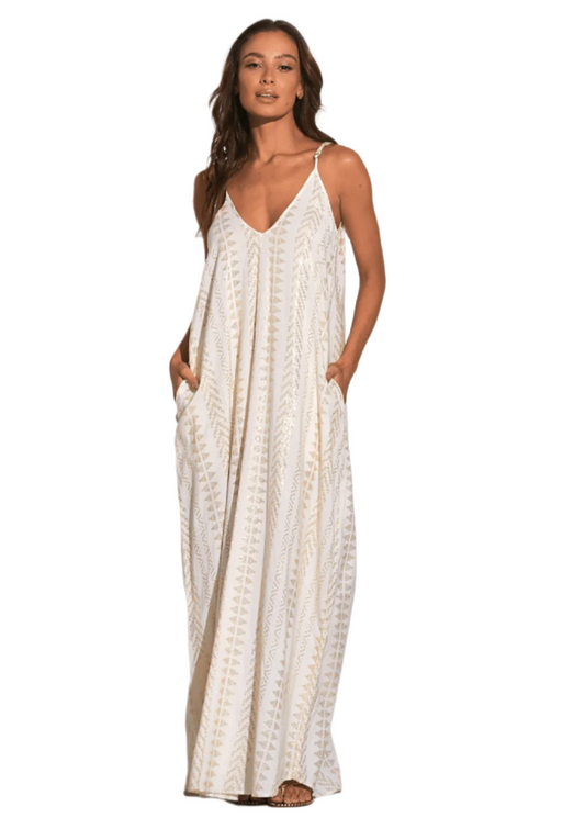 Woman wearing white with gold triangle pattern maxi dress with pockets at Mimiluca Boutique.