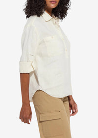 Woman wearing a white shirt and beige pants on a white background